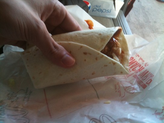A chicken strip wrapped with lettuce, BBQ sauce and taco bell cheese in a tortilla. OH YEAH!